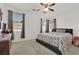 This main bedroom features carpeted floors, a ceiling fan, and windows for natural light at 6705 Frances Celia Ave, Las Vegas, NV 89122