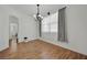 Bright dining room with hardwood floors, elegant chandelier, and neutral decor at 6705 Frances Celia Ave, Las Vegas, NV 89122
