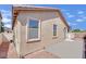 Exterior home view showing a tan stucco exterior, concrete patio and gravel landscaping at 6705 Frances Celia Ave, Las Vegas, NV 89122