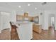 Bright kitchen featuring wood cabinetry, a breakfast bar, and modern appliances at 6705 Frances Celia Ave, Las Vegas, NV 89122