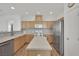 Eat-in kitchen features wood cabinets and stainless steel appliances at 6705 Frances Celia Ave, Las Vegas, NV 89122