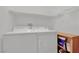 Efficient laundry room with a white washer, dryer, and shelf at 6705 Frances Celia Ave, Las Vegas, NV 89122