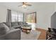 Comfortable living room with hardwood floors, large sectional couch, and ample natural light at 6705 Frances Celia Ave, Las Vegas, NV 89122