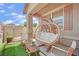 Comfortable outdoor patio with hanging swing chair and cozy seating arrangement at 6705 Frances Celia Ave, Las Vegas, NV 89122