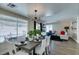 Inviting dining room with natural light, stylish chandelier, and open layout to the comfortable living area at 6736 Quinella Dr, Las Vegas, NV 89103