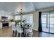 Dining area with a modern table, sliding door access to the pool, and a view of the kitchen at 6736 Quinella Dr, Las Vegas, NV 89103