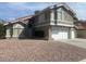 Inviting two-story home featuring a two-car garage and low-maintenance desert landscaping at 6736 Quinella Dr, Las Vegas, NV 89103