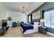 Spacious bedroom featuring a decorative accent wall, soft natural light, and comfortable furnishings at 6736 Quinella Dr, Las Vegas, NV 89103