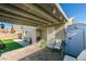 Charming backyard featuring a covered patio, outdoor seating, artificial grass, shed, and brick pavers at 709 Jonathan Glen Way, Las Vegas, NV 89145