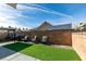 Well-maintained backyard featuring artificial grass, seating, and a block wall for privacy and relaxation at 709 Jonathan Glen Way, Las Vegas, NV 89145