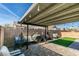Outdoor space with a covered patio, seating, artificial grass, and brick pavers create a nice backyard at 709 Jonathan Glen Way, Las Vegas, NV 89145