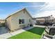 The exterior view of this backyard features artificial grass, a covered patio, and block wall, ideal for outdoor enjoyment at 709 Jonathan Glen Way, Las Vegas, NV 89145