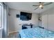 Relaxing bedroom featuring a large TV, window, and comfortable bed with blue and white floral bedding at 709 Jonathan Glen Way, Las Vegas, NV 89145