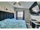 Bedroom with ceiling fan, window, mounted TV and hardwood floors at 709 Jonathan Glen Way, Las Vegas, NV 89145