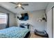 Bedroom featuring ceiling fan, window, mounted TV and pet bed at 709 Jonathan Glen Way, Las Vegas, NV 89145