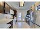 Galley kitchen with stainless steel appliances and backyard access at 709 Jonathan Glen Way, Las Vegas, NV 89145