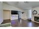 Inviting living room features wood floors, a fireplace, and a TV on a floating shelf at 709 Jonathan Glen Way, Las Vegas, NV 89145