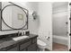 Bathroom featuring a round mirror, modern fixtures, and a toilet at 7165 N Grand Canyon Dr, Las Vegas, NV 89149