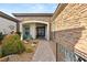 Inviting front entrance with stone accents, arched entry, and desert landscape at 7165 N Grand Canyon Dr, Las Vegas, NV 89149