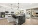 Bright kitchen with white cabinets, a gray island, and stainless steel appliances at 7165 N Grand Canyon Dr, Las Vegas, NV 89149