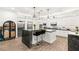 Well-equipped kitchen with white cabinetry, large island, and stainless steel appliances at 7165 N Grand Canyon Dr, Las Vegas, NV 89149