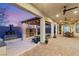 Inviting covered patio featuring an outdoor kitchen, pizza oven, fireplace, and comfortable seating area at 7165 N Grand Canyon Dr, Las Vegas, NV 89149