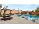 A stunning backyard pool with in-pool loungers and a connected jacuzzi, perfect for relaxation and entertainment at 7165 N Grand Canyon Dr, Las Vegas, NV 89149