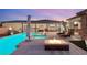 Backyard pool and patio area featuring a fire pit and lounge chairs, creating an inviting outdoor retreat at 7165 N Grand Canyon Dr, Las Vegas, NV 89149