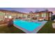 Backyard pool surrounded by lush greenery and a well-maintained patio area, creating a private oasis at 7165 N Grand Canyon Dr, Las Vegas, NV 89149