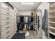 Spacious walk-in closet with custom shelving, drawers, and ample storage for clothes and accessories at 7165 N Grand Canyon Dr, Las Vegas, NV 89149