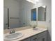 Bright bathroom featuring double sinks and a large mirror at 7246 Spring Flower Ave, Las Vegas, NV 89117