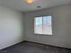 Cozy bedroom with a large window providing natural light and neutral carpet at 7246 Spring Flower Ave, Las Vegas, NV 89117