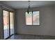 Bright dining room featuring tile floors, sliding glass doors, and a modern chandelier at 7246 Spring Flower Ave, Las Vegas, NV 89117