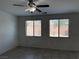 Living room with ceramic tile flooring, ceiling fan, and windows at 7246 Spring Flower Ave, Las Vegas, NV 89117