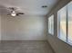 Bright living room with tile floors, ceiling fan, and windows at 7246 Spring Flower Ave, Las Vegas, NV 89117