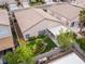 Aerial of backyard with patio cover, manicured green space, and barbecue area at 7892 Nookfield Dr, Las Vegas, NV 89147