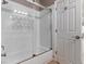 Bathtub in a bathroom featuring white subway tile surround, glass door, and white walls at 7892 Nookfield Dr, Las Vegas, NV 89147