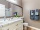 Bathroom vanity featuring a granite countertop, a decorative mirror, and stylish hardware at 7892 Nookfield Dr, Las Vegas, NV 89147