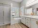 Bathroom features a tub and shower combination, double sinks, and plantation shutters at 7892 Nookfield Dr, Las Vegas, NV 89147