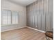 Bedroom with wood-look floors, decorative wall accents, and window with shutters at 7892 Nookfield Dr, Las Vegas, NV 89147