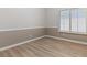 This bedroom features wood flooring, neutral paint, and a bright window with shutter blinds at 7892 Nookfield Dr, Las Vegas, NV 89147