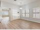 Bright dining room with wood floors, built-in shelving, shuttered windows, and stylish light fixture at 7892 Nookfield Dr, Las Vegas, NV 89147