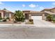 Inviting single-story home with desert landscaping and a spacious driveway at 7892 Nookfield Dr, Las Vegas, NV 89147