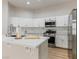 Modern kitchen featuring a center island with white countertop and stainless steel appliances at 7892 Nookfield Dr, Las Vegas, NV 89147