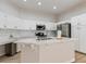 Bright kitchen with stainless steel appliances, a center island with a breakfast bar, and white cabinets at 7892 Nookfield Dr, Las Vegas, NV 89147