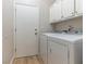 Laundry room with white washer and dryer, white cabinets and a white door at 7892 Nookfield Dr, Las Vegas, NV 89147