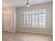 Open living room featuring wood floors, a ceiling fan, and large windows with white shutters at 7892 Nookfield Dr, Las Vegas, NV 89147
