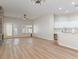 Spacious living area with wood floors, stone fireplace, and a view of the kitchen at 7892 Nookfield Dr, Las Vegas, NV 89147