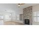 Open-concept living room with a stone fireplace, built-ins, and wood-look flooring at 7892 Nookfield Dr, Las Vegas, NV 89147