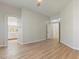 Bright main bedroom with wood floors and open access to ensuite bathroom and walk-in closet at 7892 Nookfield Dr, Las Vegas, NV 89147